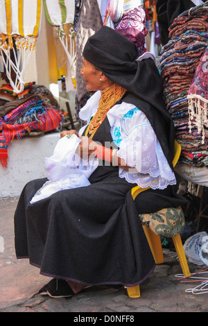 Old woman crafting on a market in Otavalo, Ecuador. Stock Photo