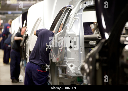 car factory workers on motor vehicle assembly line Stock Photo