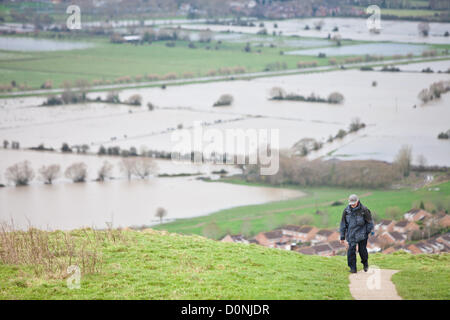 Glastonbury, United Kingdom-November 27th. Tourist on path on Glastonbury Tor.Flood water in the fields surrounding the Glastonbury Tor on the Somerset Levels. Photograph taken from elevated Glastonbury Tor, Glastonbury, Somerset, England. Stock Photo