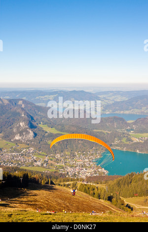 paragliding over mountains and Wolfgangsee lake in austrian Alps Stock Photo