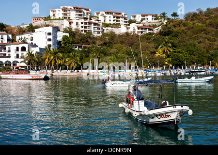 harbor with flotilla of excursion boats at port of Santa Cruz bahia de Santa Cruz planned tourist development Huatulco Mexico Stock Photo