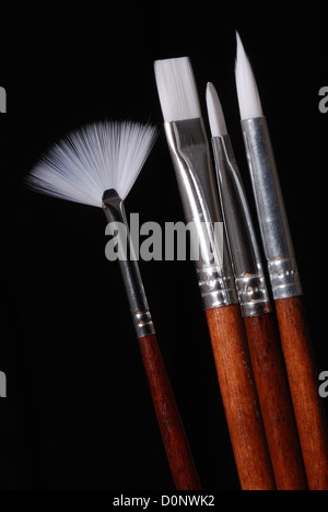 A set of artist's paint brushes, isolated on black. Stock Photo