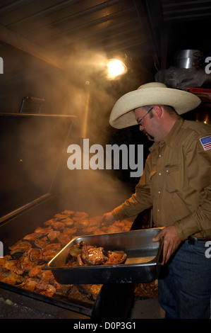 Outdoor barbeque, BBQ grill pit with fresh fish, sardines. Orange and ...