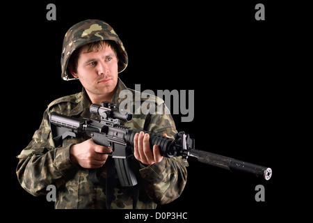 Arming soldier and a rifle Stock Photo
