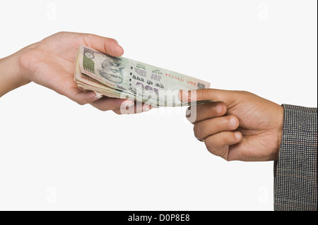 Woman giving money to a man Stock Photo