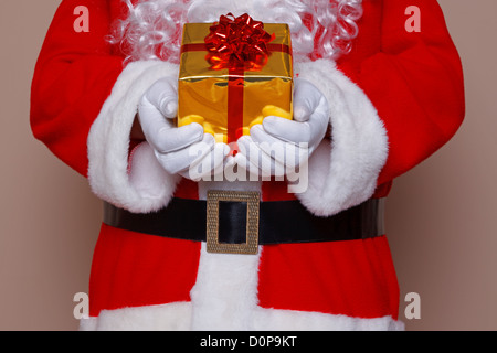 Santa Claus delivering gift wrapped presents under the tree on ...