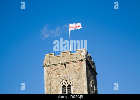 Flag of England, the St George's Cross, flying from church tower flagpole, Suffolk, England Stock Photo