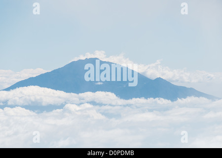 MT KILIMANJARO, Tanzania - The summit of Mt Meru pokes through the clouds as seen from Arrow Glacier on Mt Kilimanjaro's Lemosho Route. Stock Photo