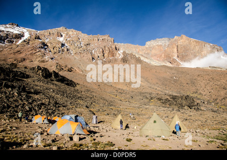 MT KILIMANJARO, Tanzania - The campsite set up a Lava Tower (15,215 feet), with the Western Breach behind it, on Mt Kilimanjaro's Lemosho Route. Stock Photo