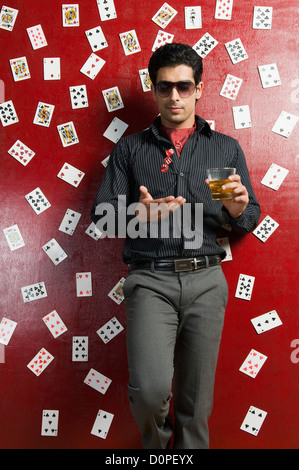 Man drinking whiskey and tossing dices Stock Photo
