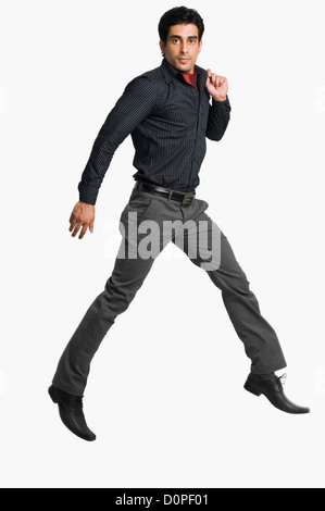 Portrait of a man jumping against a white background Stock Photo