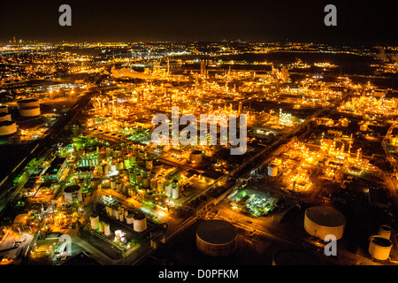 LINDEN/ELIZABETH, New Jersey, United States — An aerial view of the Bayway Refinery, captured at night from a helicopter at approximately 500 feet altitude, reveals the sprawling industrial complex brilliantly illuminated against the darkness. The intricate network of lights outlines the refinery's structures, tanks, and processing units, creating a striking industrial landscape on the border of Linden and Elizabeth, NJ. Note: Some high ISO noise is visible at full resolution due to the challenging low-light conditions of night aerial photography. Stock Photo