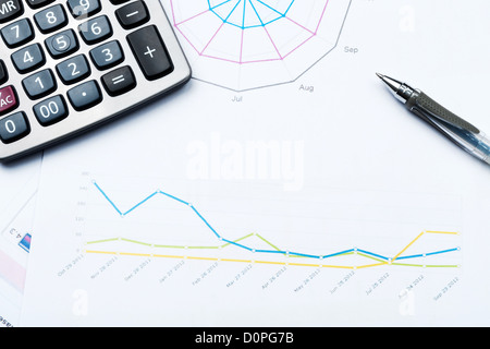 Business graph printed on white paper with calculator and glasses Stock Photo