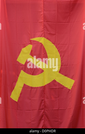 VIENTIANE, Laos - A hammer and sickle, the flag of international communism. The hammer is symbolic of the industrial proletariat, while the sickle is symbolic of the agricultural peasantry. Stock Photo