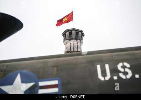 HANOI, Vietnam — A captured U.S. Air Force aircraft is displayed among other military equipment in the outdoor exhibition area of the Vietnam Military History Museum near the Flag Tower. The museum's collection includes various captured military hardware from the Vietnam War period. This display of war materiel stands as a testament to the conflict's scope and scale. Stock Photo