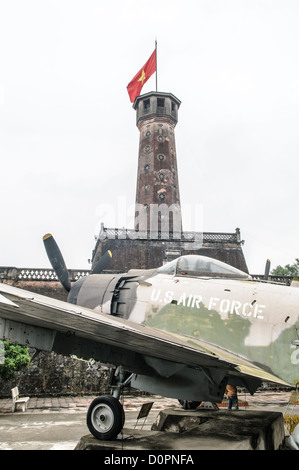 HANOI, Vietnam — A captured U.S. Air Force aircraft is displayed among other military equipment in the outdoor exhibition area of the Vietnam Military History Museum near the Flag Tower. The museum's collection includes various captured military hardware from the Vietnam War period. This display of war materiel stands as a testament to the conflict's scope and scale. Stock Photo