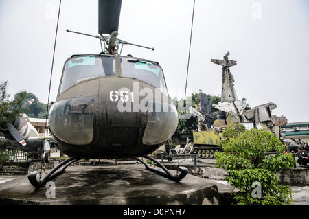 HANOI, Vietnam — A collection of captured U.S. military aircraft, including helicopters and planes, is displayed in the outdoor exhibition area of the Vietnam Military History Museum. These aircraft form part of the museum's extensive collection of military equipment from the Vietnam War period. The display showcases various types of American military aviation equipment captured during the conflict. Stock Photo