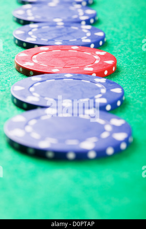 Red chip in line of blue Stock Photo