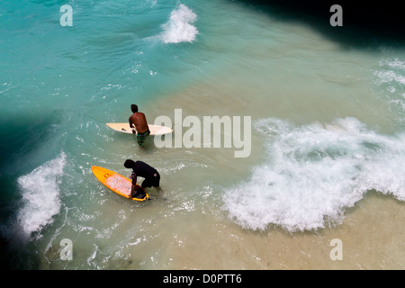 Surfers in the Indian Ocean at Suluban Beach on Bali, Indonesia Stock Photo