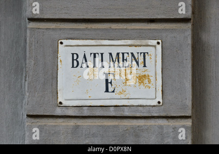 HANOI, Vietnam - A sign for Batiment E o (or cell block E) in Hoa Lo Prison. Hoa Lo Prison, also known sarcastically as the Hanoi Hilton during the Vietnam War, was originally a French colonial prison for political prisoners and then a North Vietnamese prison for prisoners of war. It is especially famous for being the jail used for American pilots shot down during the Vietnam War. Stock Photo