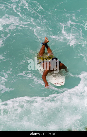 Surfers in the Indian Ocean at Suluban Beach on Bali, Indonesia Stock Photo