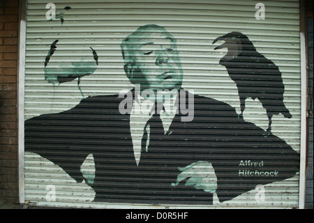 Alfred Hitchcock painting on storefront roll-door along Hollywood Blvd in Los Angeles, CA Stock Photo