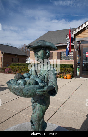 A statue of Johnny Appleseed welcomes visitors to the Massachusetts Visitor Center in Lancaster, Massachusetts. Stock Photo