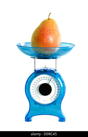 Pear on kitchen scale Stock Photo