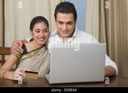 Couple doing home shopping on a laptop Stock Photo