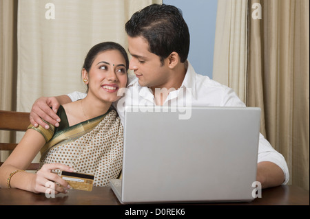 Couple doing home shopping on a laptop Stock Photo