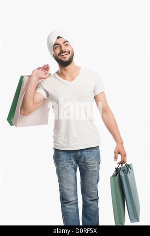 Man carrying shopping bags and smiling Stock Photo