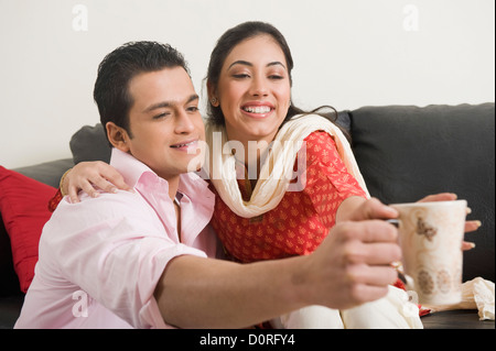 Couple having fun with a cup of coffee Stock Photo