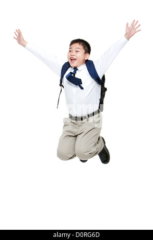 Carefree schoolboy jumping in mid-air with excitement Stock Photo