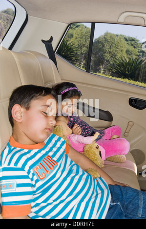 Children sleeping in a car Stock Photo
