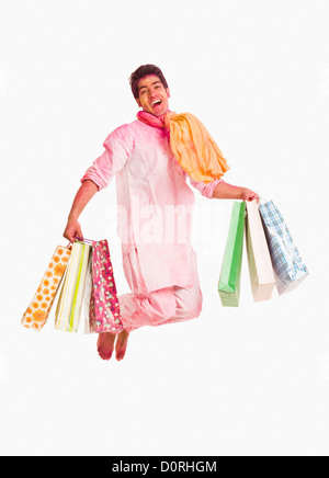 Man carrying shopping bags on Holi Stock Photo