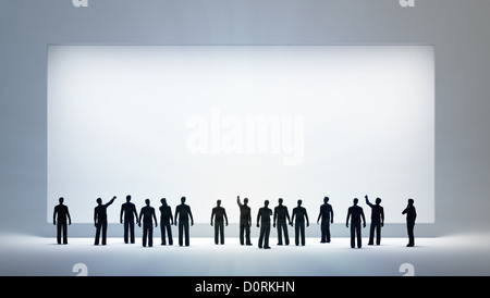 tiny people looking at an empty white board Stock Photo