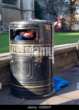 Busker in a bin, Cambridge, UK Stock Photo