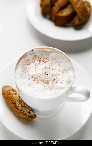 Cup of white coffee with cantuccini cookies Stock Photo