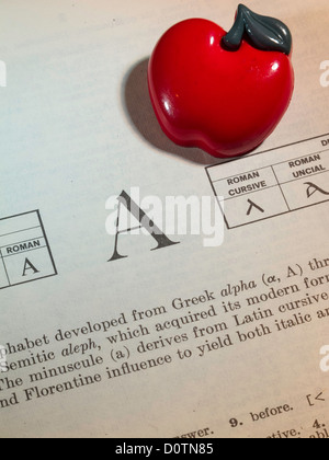 The Letter A In the Dictionary with Apple, Still Life Stock Photo