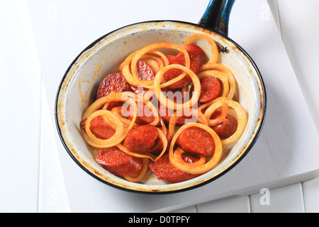 Hot sausage stir fry in a pan Stock Photo