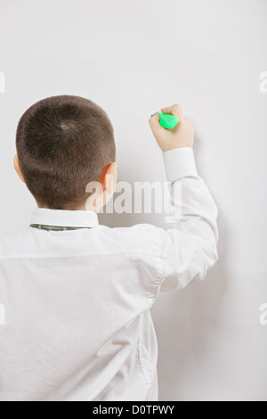 A boy writing on the whiteboard Stock Photo - Alamy