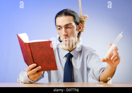 Man reading bible and taking drugs Stock Photo