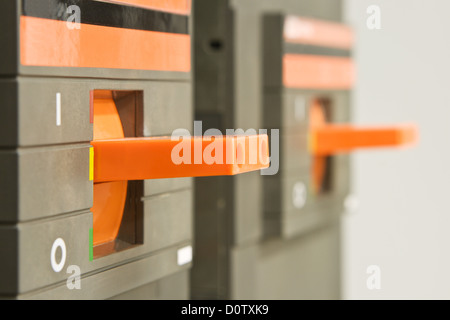 Orange circuit breaker on control panel Stock Photo