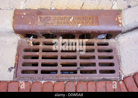 Storm drain grate with dump no waste drains to river warning. Oak Park Illinois Stock Photo