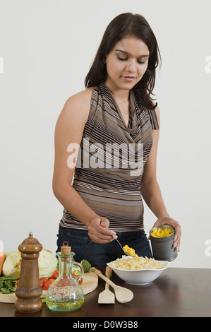 Woman preparing pasta in the kitchen Stock Photo