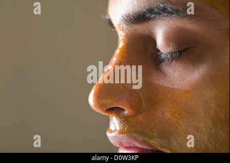 Close-up of a man with peel off mask Stock Photo