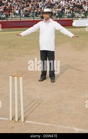 Cricket umpire signaling Wide Ball Stock Photo