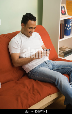 Man text messaging on a mobile phone Stock Photo