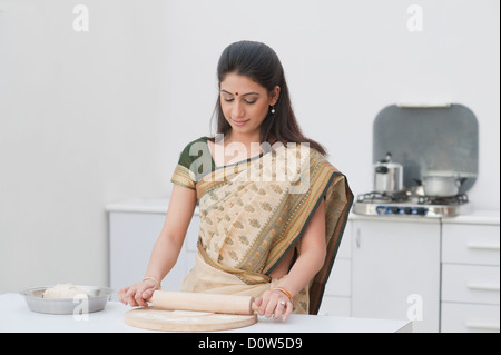 Woman making chapatti in the kitchen Stock Photo