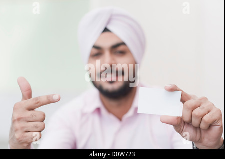 Businessman showing a blank business card Stock Photo